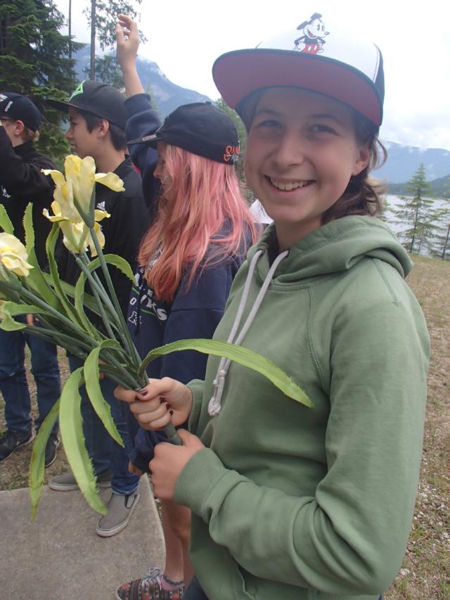 Nakusp Grade 7 students getting up close to yellow flag iris